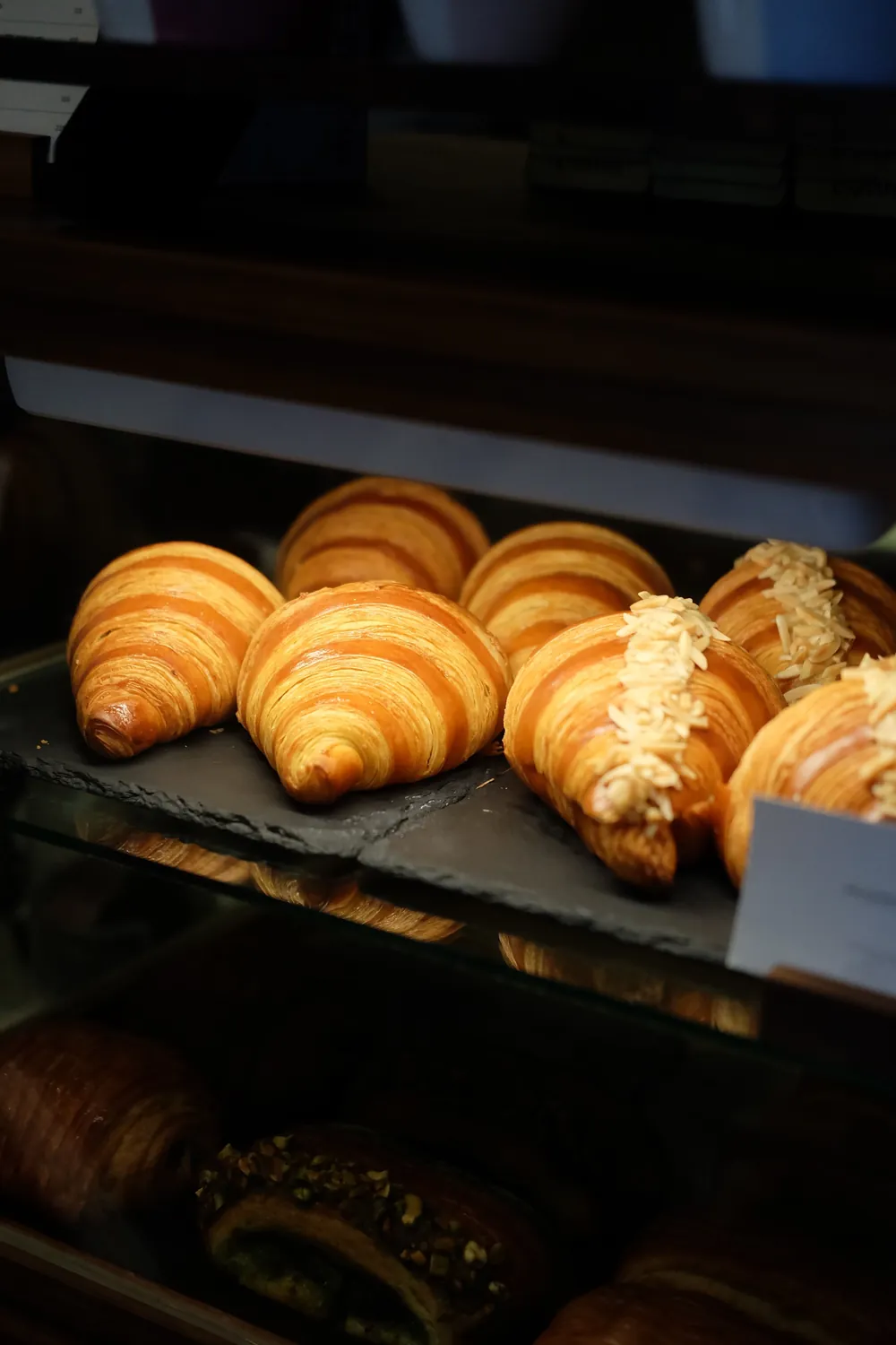 Golden croissants in the bakery display case